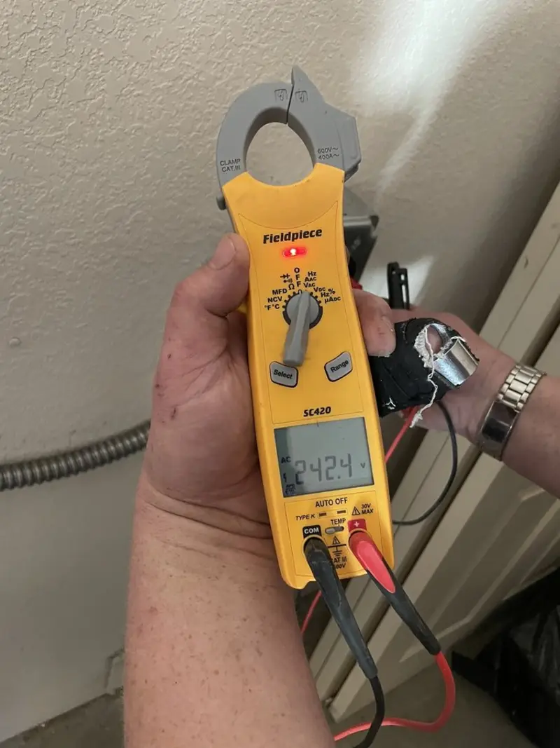 Voltage testing with clamp meter during Ceiling Fan Installation in Morton